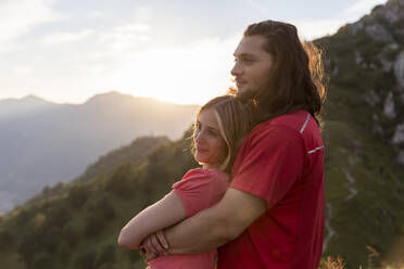Young couple embracing in the mountains - MCVF00017