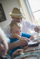 Father and son at table - JOHF00173