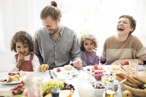 Happy family having lunch at home stock photo