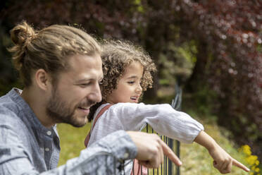 Happy father with son in garden - MJFKF00026