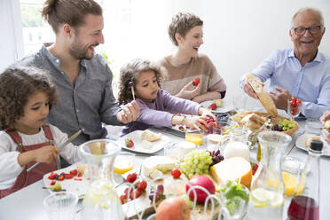 Happy extended family having lunch at home - MJFKF00116