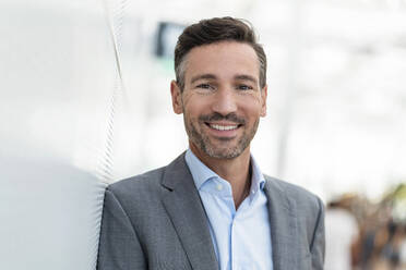 Portrait of smiling businessman in the city - DIGF08421