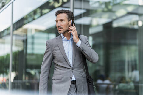 Businessman on cell phone in the city stock photo