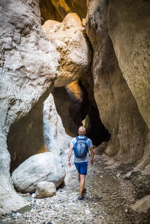 Tourist hiking in Saklikent Gorge, Saklikent National Park, Fethiye Province, Lycia, Anatolia, Turkey, Asia Minor, Eurasia - RHPLF09216