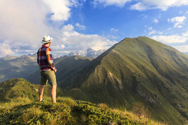 Mann auf dem Gipfel des Monte Rolla mit Blick auf den Monte Disgrazia und den Sasso Canale, Provinz Sondrio, Valtellina, Lombardei, Italien, Europa - RHPLF09241