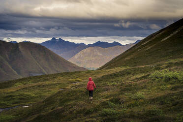 Lone hiker walks into Alaskan wilderness, Alaska, United States of America, North America - RHPLF09268