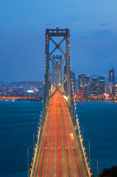 View of San Francisco skyline and Oakland Bay Bridge from Treasure Island at dusk, San Francisco, California, United States of America, North America - RHPLF09443