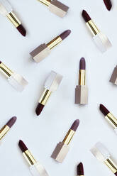 Lipsticks scattered on a white background - MOMF00768