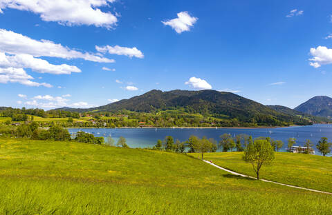 Scenic view of Lake Tegernsee and mountains against blue sky, Bavaria, Germany stock photo