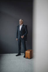 Senior businessman with old-fashioned suitcase - GUSF02587