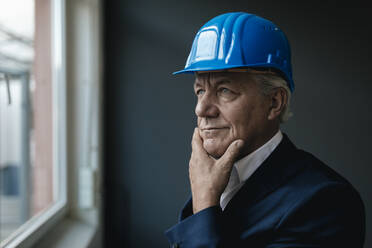 Portrait of a confident senior businessman wearing hard hat - GUSF02598