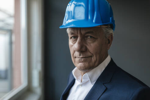 Portrait of a confident senior businessman wearing hard hat - GUSF02600