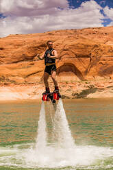 Flyboarding with Bravada Yachts on Lake Powell, border of Arizona and Utah, United States of America, North America - RHPLF09843