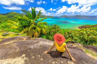 Panorama with woman looking to Cote d'Or Bay, with Curieuse, St. Pierre and Chauvre Souris Island, Anse Gouvernement, Praslin, Seychelles, Indian Ocean, Africa - RHPLF09855