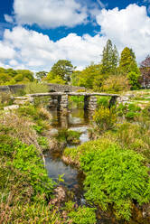 Medieval clapper bridge over the East Dart River at Postbridge on Dartmoor in Devon, England, United Kingdom, Europe - RHPLF10257