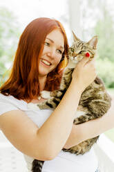 Young woman holding cat - JOHF00288