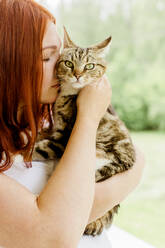 Young woman holding cat - JOHF00289