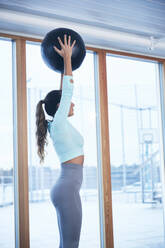 Frau trainiert im Fitnessstudio - JOHF00373