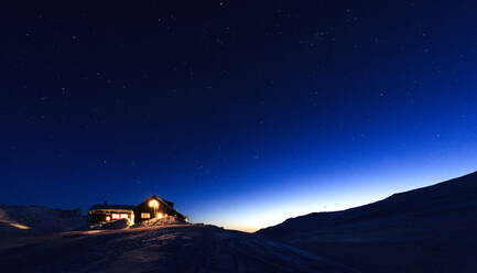 Illuminated house at winter - JOHF00380