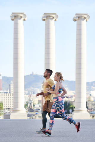 Man and woman running in the city stock photo