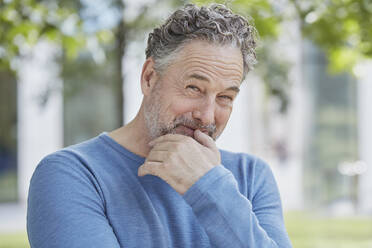 Portrait of smiling mature man in a park - RORF01937