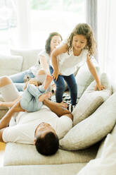 Family playing together in living room - JOHF00470