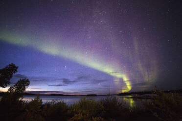 The Northern Lights (aurora borealis) in the night sky above Lake Egenolf in northern Manitoba, Canada, North America - RHPLF10775