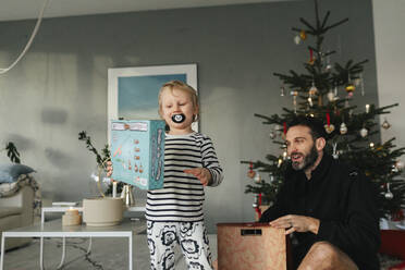 Father with son unpacking Christmas presents - JOHF00920