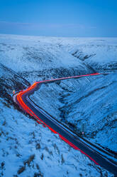 Winter landscape and trail lights on Snake Pass, Peak District National Park, Derbyshire, England, United Kingdom, Europe - RHPLF10972