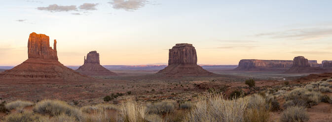 The giant sandstone buttes glowing pink at sunset in Monument Valley Navajo Tribal Park on the Arizona-Utah border, United States of America, North America - RHPLF11065