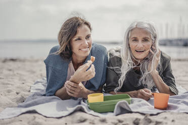 Mutter und Tochter machen ein Picknick am Strand - JOSF03697