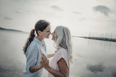 Mother and daughter spending a day at the sea - JOSF03739