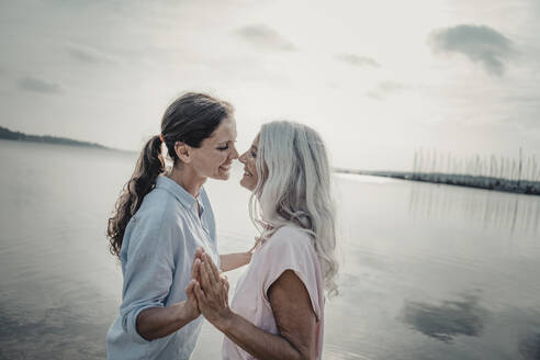 Mother and daughter spending a day at the sea - JOSF03739