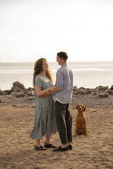 Young couple with dog at the beach - VPIF01518
