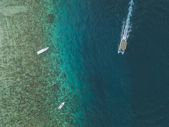Aerial view of boats on sea at Gili-Air Island in Bali, Indonesia - KNTF03433