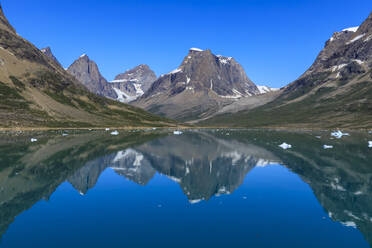 Reflections, beautiful mountains, rugged South Skjoldungen Fjord and Island, glorious weather, remote South East Greenland, Denmark, Polar Regions - RHPLF11149