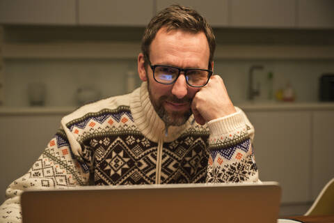 Casual businessman using laptop on table at home stock photo