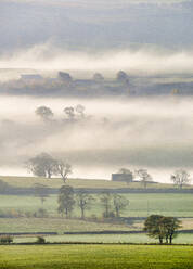 Mist rising over East Halton and Embsay in Lower Wharfedale, North Yorkshire, Yorkshire, England, United Kingdom, Europe - RHPLF11797