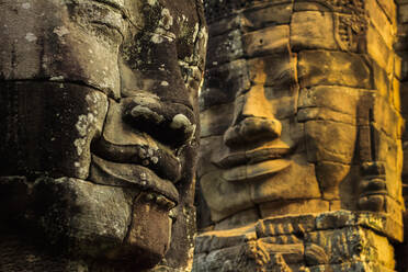 T wo of 216 smiling sandstone faces at 12th century Bayon, King Jayavarman VII's last temple in Angkor Thom, Angkor, UNESCO World Heritage Site, Siem Reap, Cambodia, Indochina, Southeast Asia, Asia - RHPLF11849