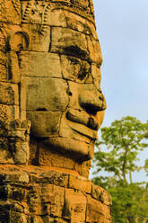 One of 216 smiling sandstone faces at 12th century Bayon, King Jayavarman VII's last temple in Angkor Thom, Angkor, UNESCO World Heritage Site, Siem Reap, Cambodia, Indochina, Southeast Asia, Asia - RHPLF11853