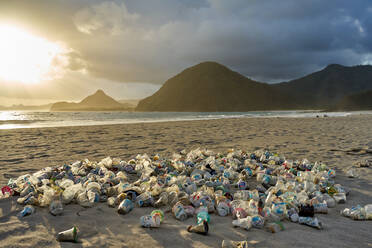 Pile of plastic rubbish dumped on the sand at sunset on Selong Belanak Beach on Lombok, Indonesia, Southeast Asia, Asia - RHPLF11953