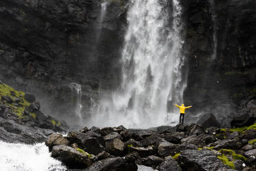 Hiker at Fossa waterfall, Streymoy island, Faroe Islands, Denmark, Europe - RHPLF12114