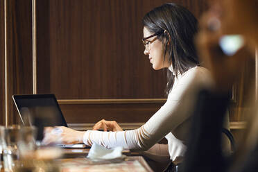 Geschäftsfrau mit Laptop in einem Restaurant - JSRF00602