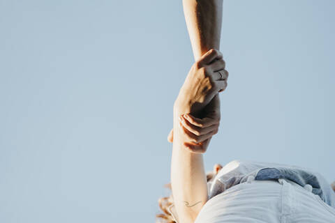 Young couple holding hands, from above stock photo