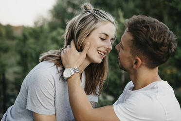 Portrait of young kissing couple - LHPF00868