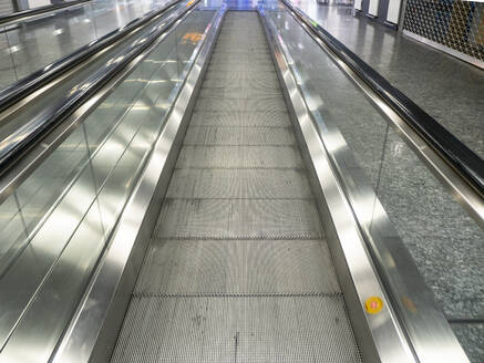 Diminishing perspective of empty moving walkway at airport - AMF07302