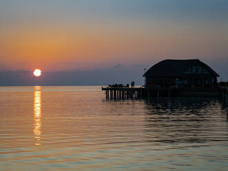 Silhouette stilt house at South Male Atoll against sky, Maldives - AMF07305