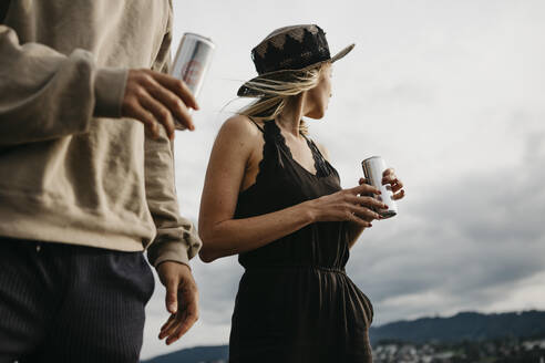 Young couple having a drink outdoors - LHPF00916