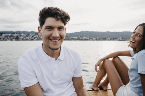 Happy young couple on a boat trip on a lake stock photo
