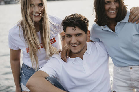 Portrait of happy friends on a boat trip on a lake stock photo